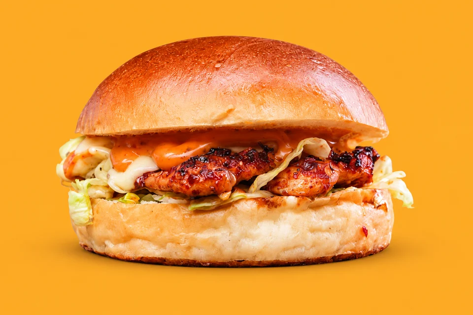 Fire Bird burger with peri peri grilled chicken, cheese and fresh vegetables in a soft bun